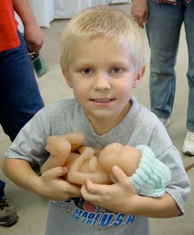 Photo: boy holding fetal model